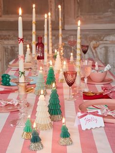 the table is set with candles and plates