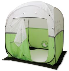 a green and white tent sitting on top of a black base