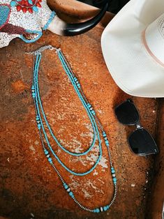 Triple Strand Turquoise And Navajo Inspired Necklace | Gussied Up Online Boutique Elevate your look with our Triple Strand Turquoise And Navajo Inspired Necklace! Handmade with tiny 4mm synthetic turquoise, this 3-strand necklace comes in varying lengths (26", 30", 36"), with a 5" extender for versatility. The clustered navajo pearl and turquoise add a touch of elegance. Nickel, lead, and chrome free for worry-free wear. Women's Western Wear, Trending Jewelry, Western Boutique, Western Wear For Women, Inspired Necklace, Southwestern Jewelry, Sterling Jewelry, Wedge Heel Sandals, Women's Wear