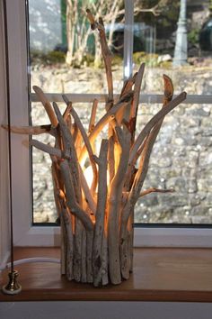 a lamp made out of driftwood sticks