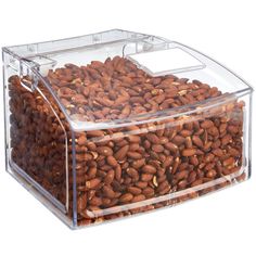 a clear box filled with nuts on top of a white surface and the lid is open