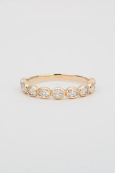 a gold ring with five diamonds on it