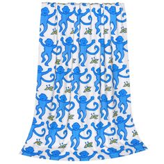 blue monkey curtains hanging on a curtain rod in front of a white background with green and blue monkeys