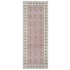 a pink and white rug with an intricate design on the bottom, in front of a white background