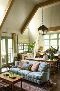 a living room filled with furniture and lots of windows