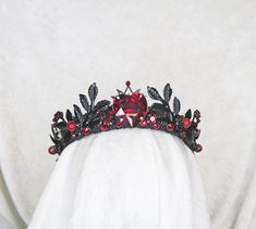 Made to order, requires 7 business days to make before it ships VALENTINE FLAMING BLACK HEART TIARA Brass findings are handstitched to a crown base Painted Black Embellished with glass gemstones and plastic beads Comfortable and flexible Fits all head sizes from children to adults. ---- One size fits all - bobby pins can easily be used for added securing Black And Red Crown Quinceanera, Heart Tiara, Black Crown With Red Jewels, Gothic Heart-shaped Wedding Jewelry, Red Heart Crown, Black Vampiric Tiara, Heart Crown, Queen Jewelry, Red Crown