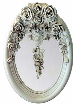 a white mirror with roses on it