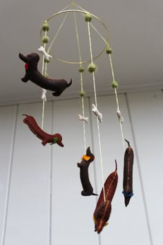 a wind chime with dachshunds hanging from it's sides and string