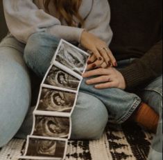 a woman sitting on the floor with her hands in her pockets and photos taped to them