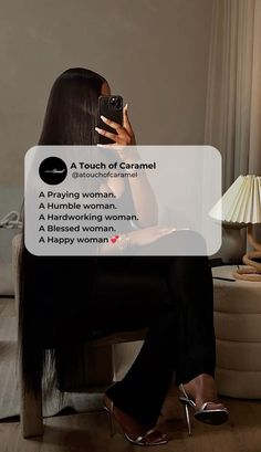 a woman sitting on a couch taking a selfie with her cell phone while wearing high heels