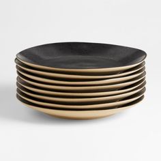 black and gold plates stacked on top of each other