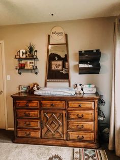 a baby crib in the corner of a room with a large mirror above it