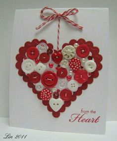 a heart shaped card with buttons attached to it