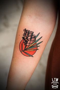 a tattoo on the arm of a person with an orange and black pineapple design