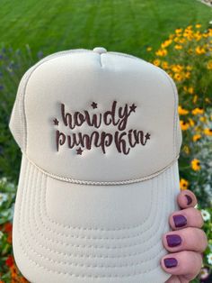 Add a touch of Southern sweetness to your style with our embroidered hat featuring the word 'howdy pumpkin' embroidered with a western script.  This classic sand-beige colored trucker cap is perfect for anyone who loves Southern charm and effortless style with colors ready for fall! Whether you're heading to a pumpkin patch, a day out with friends, or simply want to express your playful side, this hat is a must-have accessory. Details: Colors Available: Sand (Beige), Material: Polyester Foam Front truck cap with Mesh Back adjustable straps Size: One size fits most (adjustable strap) Embroidery: machine embroidered by me using high quality thread   Style: Otto foam trucker cap with a splash of western charm.     Pricing:$25 Shipping:$2 *Processing Time: 1 -2days *Shipping Time: 3-5 business Country Style Snapback Hat, Fun Adjustable Trucker Hat For Country Events, Adjustable Fun Trucker Hat For Country Events, White Fall Hat, One Size Fits Most, Fun Trucker Hat For Country Events One Size, Trendy Trucker Hat For Country Events, Adjustable White Trucker Hat For Winter, Fall Season Cap Hat As Gift, Fall Season Gift Cap Hat