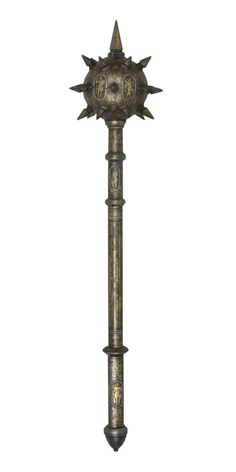 an old fashioned metal pole with spikes on it's head and two faces in the middle