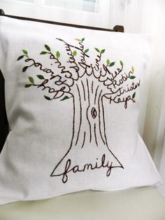 a white pillow with a family tree embroidered on it