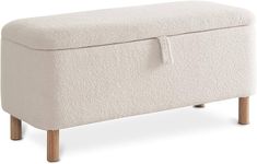 an upholstered foot stool with wooden legs and a white cover on the top