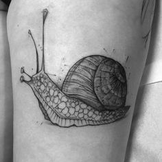 a black and white photo of a snail tattoo on the right side of the thigh