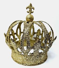 a gold glittered crown is shown against a white background