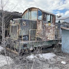 an old rusty train sitting in the middle of nowhere