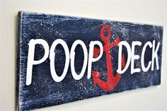 a wooden sign with an anchor and the words poop deck painted on it