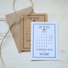 save the date cards with twine on top of each other and brown envelopes