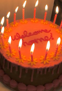 a birthday cake with lit candles on it