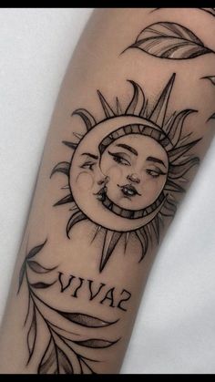 a sun and moon tattoo with the word viva on it's arm, in black ink