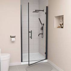 a white toilet sitting next to a shower in a bathroom on top of a tile floor