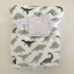 a baby blanket with an image of dinosaurs on it