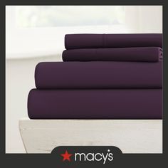 purple sheets are stacked on top of each other in front of a window with the words macy's written below them