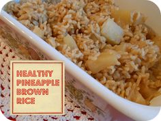 healthy pineapple brown rice in a white dish on a red and white placemat