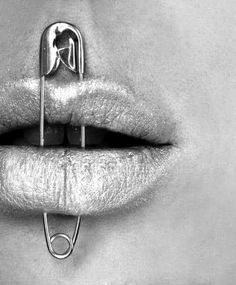 a woman's lips with scissors in the shape of a man on top of them