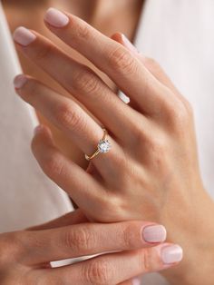 a woman's hand with a diamond ring on it