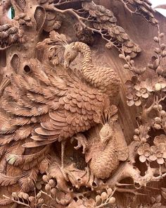 an intricately carved wooden sculpture with birds and flowers