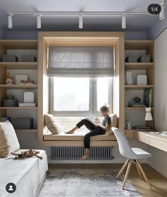 a window seat in front of a window with bookshelves on the other side