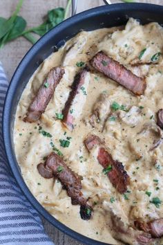 a pan filled with meat and gravy on top of a table