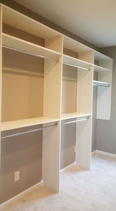 an empty room with white shelves and carpeted flooring in the middle of it