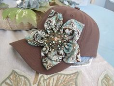 a hat with a flower on it sitting on top of a table