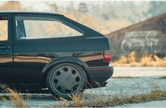 a black car parked on the side of a road