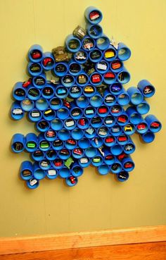 a pile of blue cups sitting on top of a yellow table next to each other