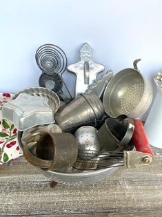 an assortment of kitchen utensils in a metal bowl