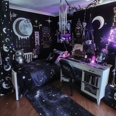 a bedroom decorated in black and white with purple lights