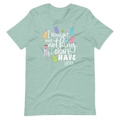 a light blue t - shirt with the words california dreaming written in colorful letters on it