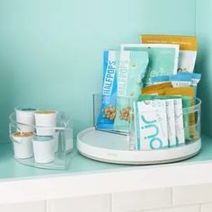 there is a cup and some snacks on the counter in this room with blue walls