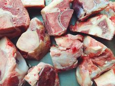 raw meats are displayed on a plate ready to be cut into bite sized pieces