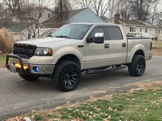 a silver truck is parked on the street