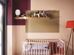 a baby crib with two dogs on top of it and a lamp next to the crib