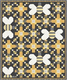 a black and yellow quilt with white hearts on the front, one heart has been cut out